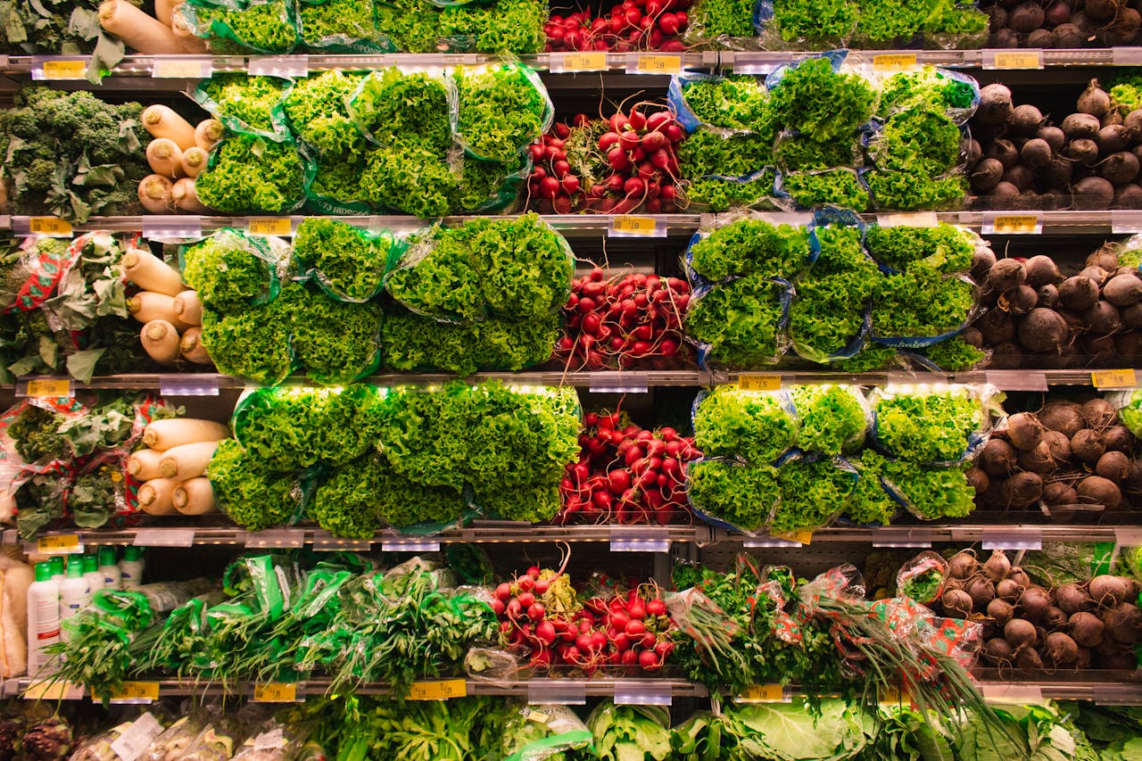 Colorful assortment of fresh vegetables arranged on supermarket shelves, perfect for healthy eating themes.